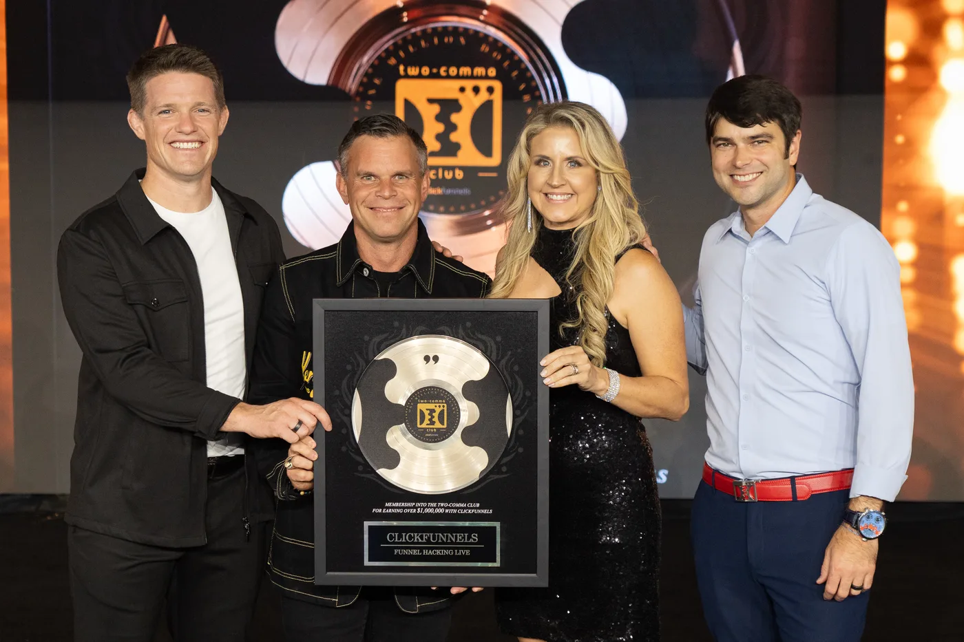 Bart and Sunny Miller receiving a Two Comma Club award in 2023 alongside Russell Brunson and Todd Dickerson.