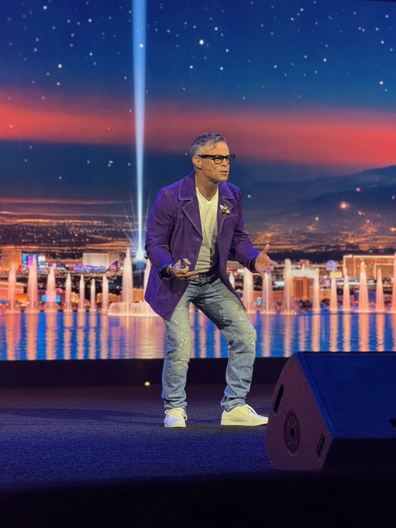Bart presenting on stage in a tailored jacket.