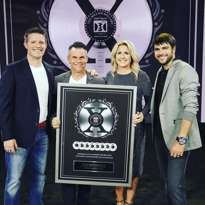 Bart and Sunny Miller receiving an Eight Figure Club award alongside Russell Brunson and Todd Dickerson.